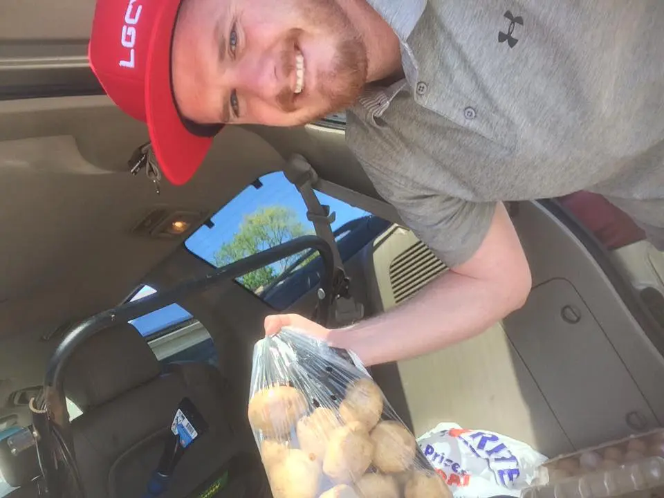 LGCY Power representative carrying potatoes